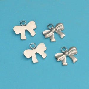 Detailed view of silver titanium steel bow pendants for DIY jewelry making and crafts