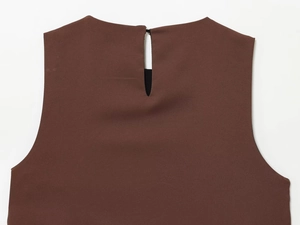Detail of chocolate brown satin top featuring a back teardrop cutout and button closure