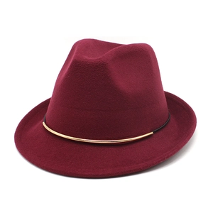 Detail of burgundy wool fedora hat featuring a stylish slim gold metal ring band decoration