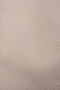 Detail shot of brown and beige micro-check pattern on a vintage plaid vest top