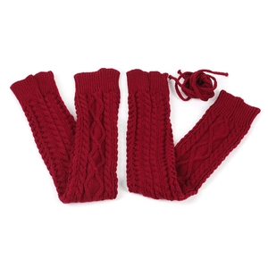 Detail of dark red cable knit leg warmers with adjustable side ties on white background