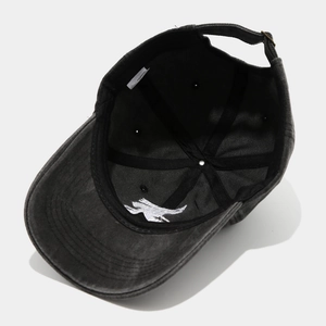 Inside view of black washed cotton baseball cap with cotton label and metal buckle