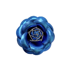 Elegant blue metallic camellia flower brooch with detailed petals on white background