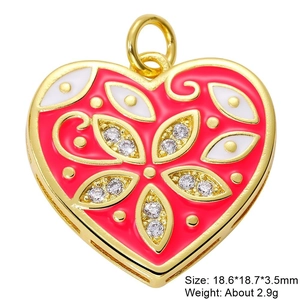 Macro shot of heart-shaped gold-plated enamel pendant with zircon stone and eye motif