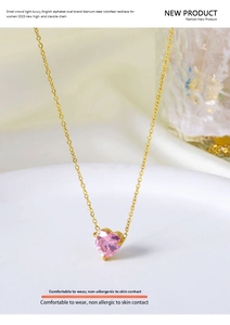 Close-up of titanium steel gold necklace featuring a pink heart-shaped zircon pendant