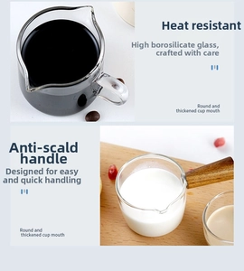 Close-up of heat-resistant borosilicate glass milk cup with scale and solid wood handle