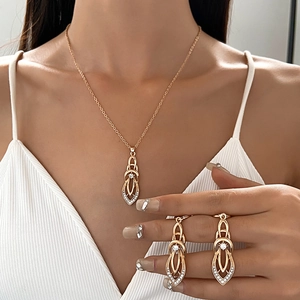 Detailed view of golden leaf-shaped geometric jewelry set with crystal accents