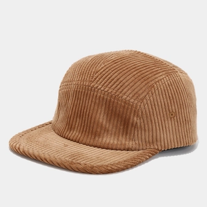 Detail of classic brown corduroy texture on vintage five-panel camper hat stitching