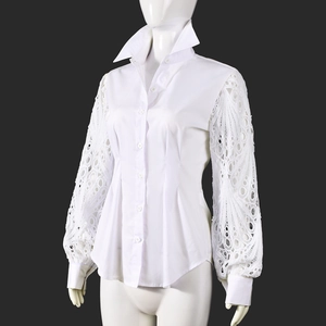 Close-up of white long sleeve shirt showing delicate hollow lace texture and cuff details