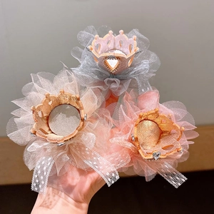 Detailed close-up of crown hair clips with lace, mesh tulle, and heart-shaped rhinestones