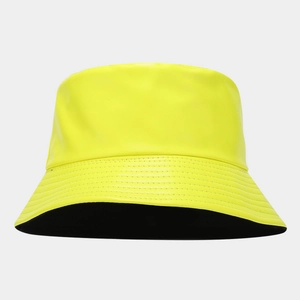 Detail of neon yellow PU leather bucket hat with precise stitching and black lining