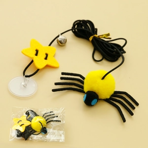 Detail of hanging spider cat toy with elastic rope, bell and suction cup attachment