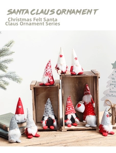 Close-up of knit Christmas gnomes with stars and snowflakes in a cozy rustic holiday setting