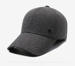 Close-up of deep grey wool baseball cap with thermal lining and side metal logo detail