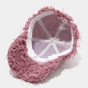 Internal view of pink plush baseball cap featuring mesh lining and reinforced stitching