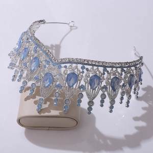 Close-up of silver bridal crown with drop-shaped blue crystals and white rhinestones