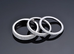 Detailed close-up of 925 silver rings with double-row micro-pave cubic zirconia settings