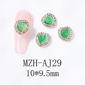 Detail of 10x9.5mm green cat-eye heart nail charm with rhinestones and gold base