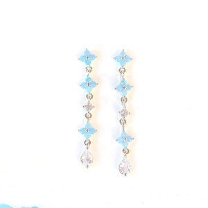 Detail of 18K gold plated flower earrings with blue zircon stones and long chain