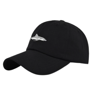 Detailed view of white shark embroidery on a black cotton canvas baseball cap