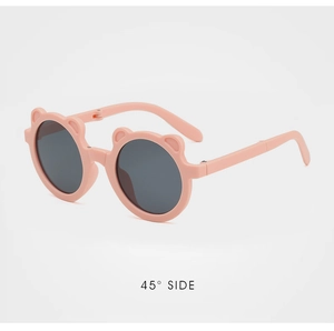 Detailed 45-degree side view of pink bear-eared foldable kids sunglasses with dark lenses