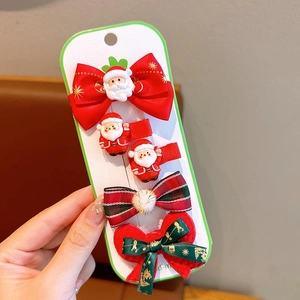Detailed set of Christmas hair clips featuring Santa Claus and red bows for girls