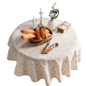 Round cream linen Christmas tablecloth with gold snowflake and bell patterns