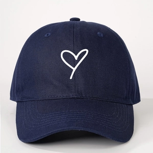 Navy blue cotton baseball cap with white heart print and adjustable curved brim