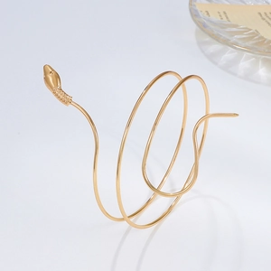 Retro golden coiled snake arm cuff bracelet with detailed serpent head on white background