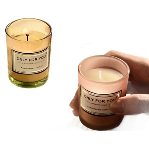 Handmade aromatherapy soy candles in amber and pink glass jars with gift packaging