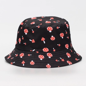 Detailed view of a black bucket hat featuring a red and white mushroom pattern design.