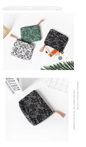 Detail view of mini paisley canvas coin purses in black, green and white with pink tassels