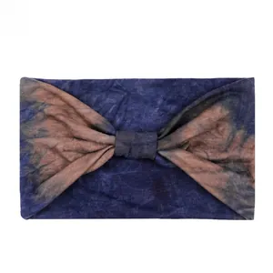 Macro detail of elastic wide headband with blue and brown tie-dye knot and soft texture