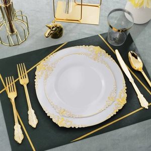 Baroque embossed white disposable plates with gold cutlery on green leather placemat