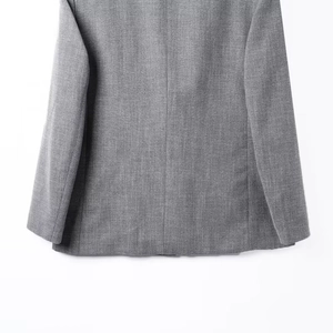 Macro detail of high-quality grey worsted suit fabric texture and hem stitching