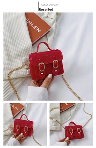 Detail of rose red jelly mini bag with gold chain strap and magnetic closure