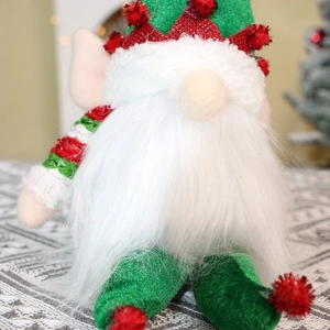 Close-up of a festive Christmas gnome with green glitter coat and white fluffy beard