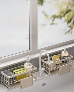 Detail of cream kitchen sink organizer with slanted drainage tray and towel bar