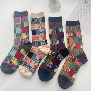 Detail view of four vintage patchwork plaid cotton crew socks with colorful patterns