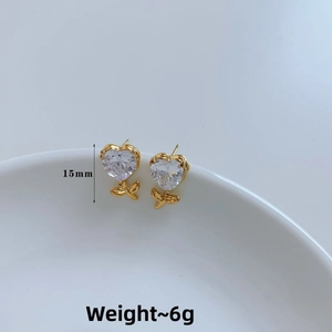 Detail view of 15mm heart-shaped cubic zirconia stud earrings with gold leaf accents