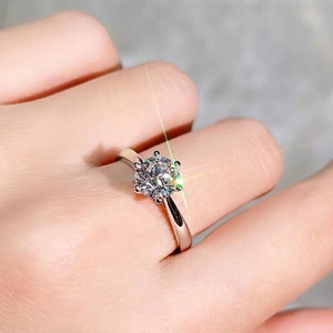 Macro shot of a classic six-prong moissanite ring with sparkling starburst light effects
