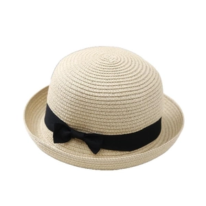 Elegant beige straw sun hat with black ribbon bow and upturned brim for beach summer
