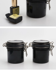 Close-up of black airtight eyelash glue storage jar with secure metal buckle seal