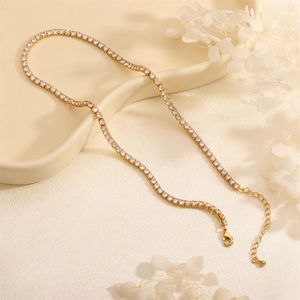 Detailed view of a gold-plated tennis necklace with round cubic zirconia and lobster clasp