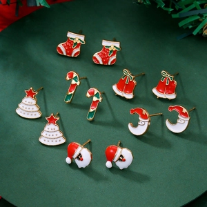 Flat lay of alloy Christmas stud earring set featuring bells and candy canes
