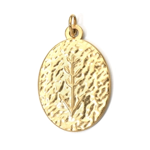Detailed view of oval hammered gold stainless steel pendant with botanical pattern
