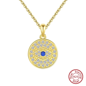 Detailed view of gold plated 925 sterling silver evil eye pendant with blue crystals