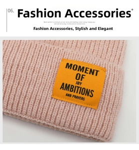 Detailed knit texture of pink sequined beanie featuring a yellow woven MOMENT label