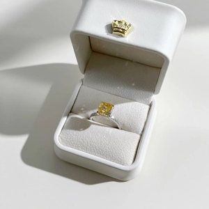 Close-up of luxury S925 silver ring with yellow square diamond in a white gift box