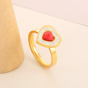 Macro detail of 18k gold plated ring featuring a red heart stone and micro-pavé crystals